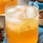 Apple cider vinegar drink in a clear glass with lemon and honey