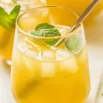 Green tea lemonade recipe served in a glass with lemon slices and mint
