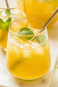 Green tea lemonade recipe served in a glass with lemon slices and mint