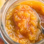 Freshly made peach jam recipe spread on toast with butter