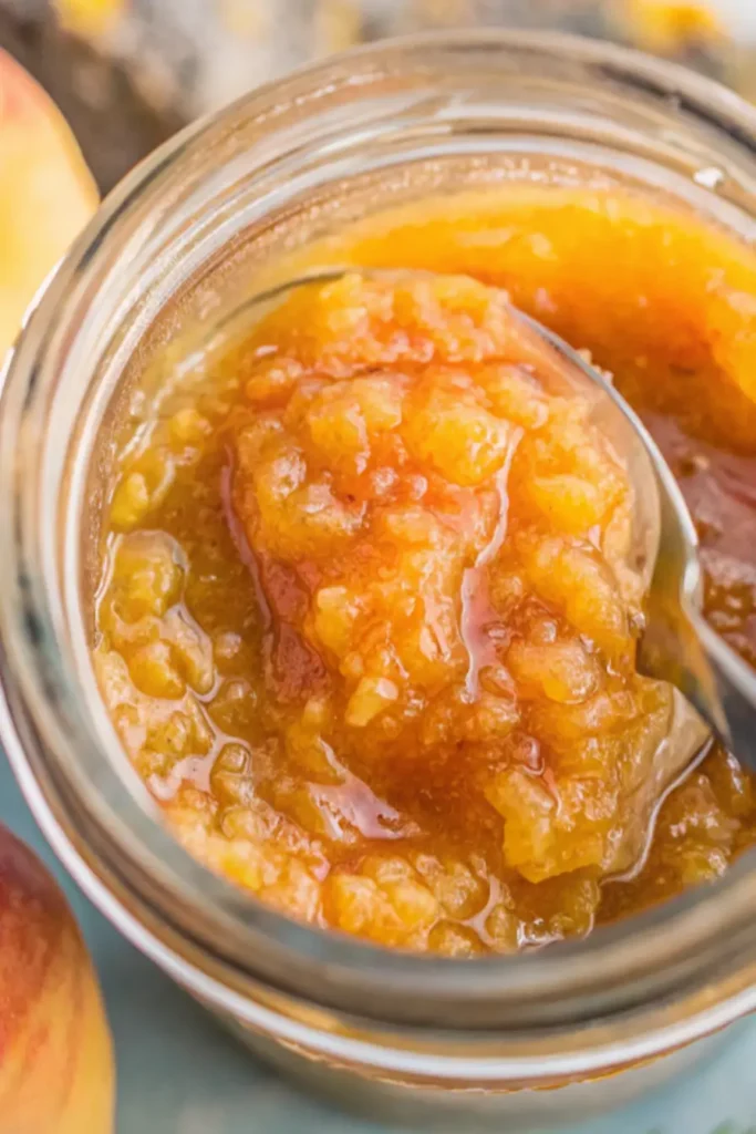 Freshly made peach jam recipe spread on toast with butter